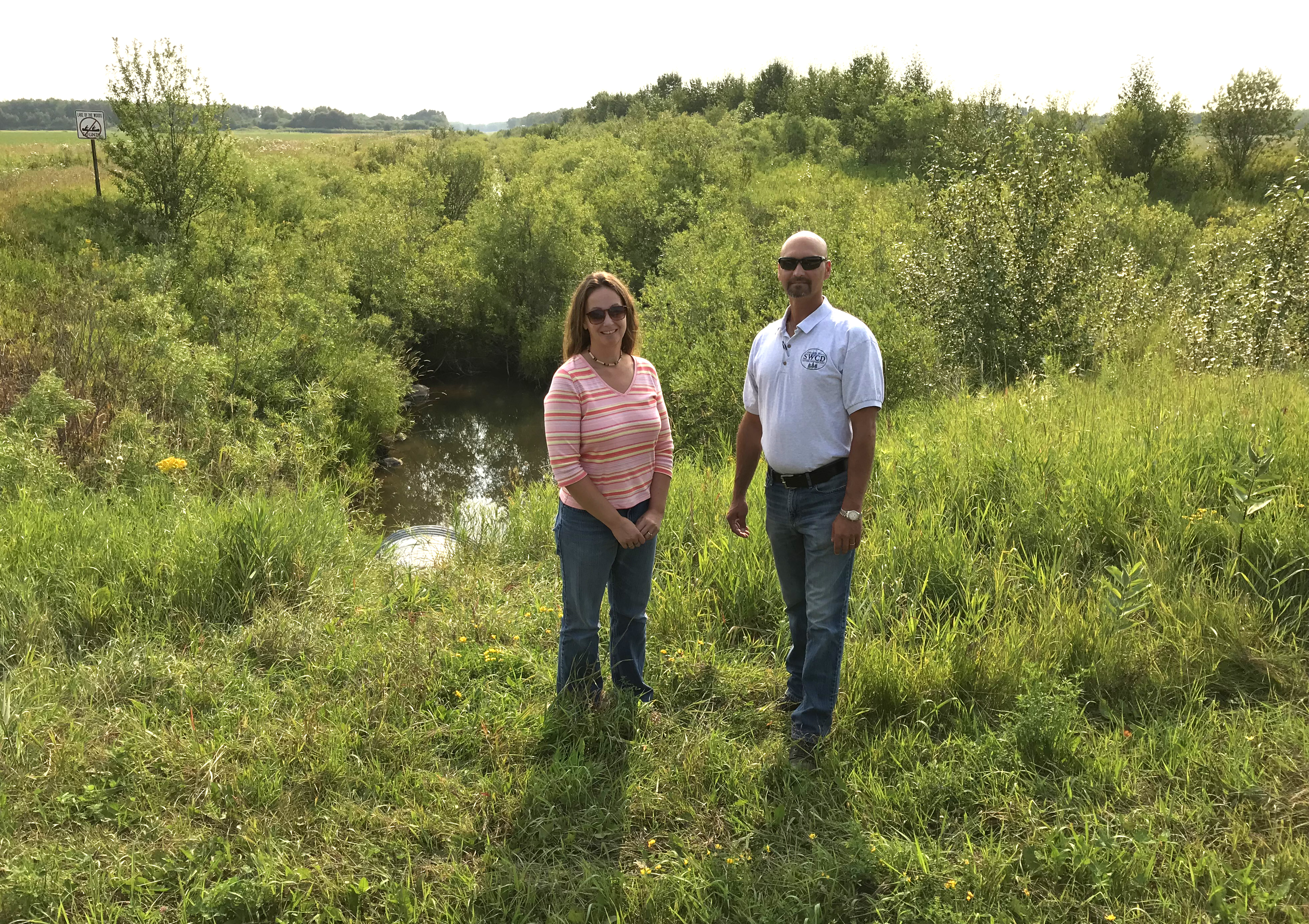 Lake of the Woods SWCD and County staff stand in front of a segment of Judicial Ditch 28 before construction began