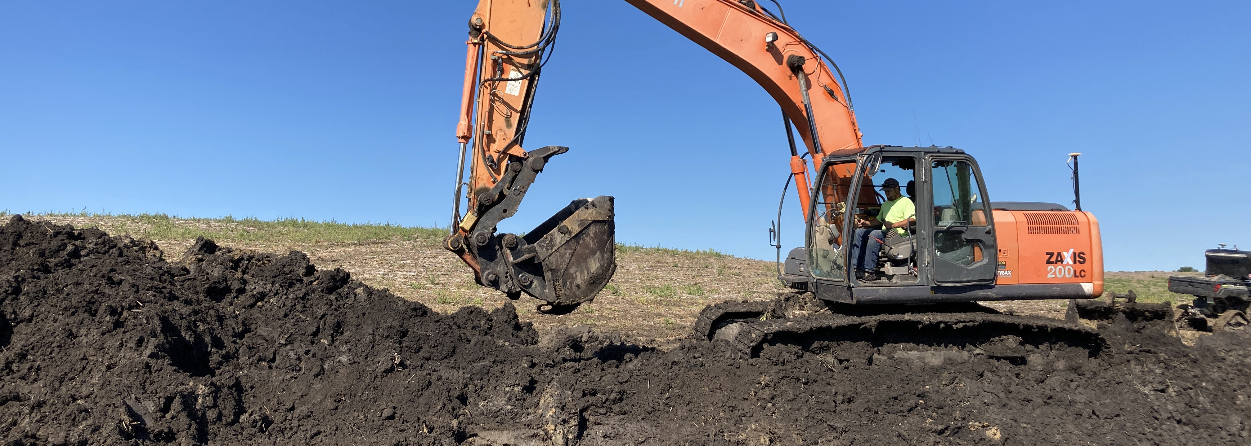 Back hoe digging up ground for conservation