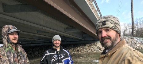 Pennington SWCD staff stand in front of the Greenwood Street bridge, which spans the Red Lake River in Thief River Falls.