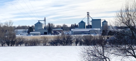 Snow covers a wellhead protection area. Adrian skyline is in the background.