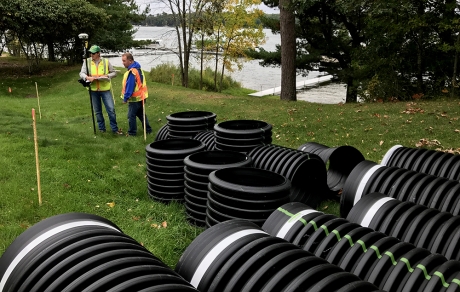 workers survey site of stormwater treatment project